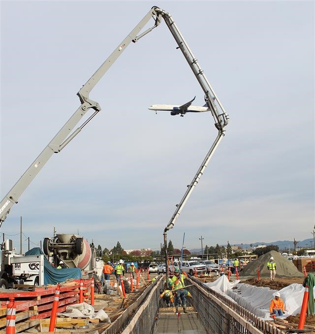 Concrete being piped into the Maintenance and Storage Facility foundation.