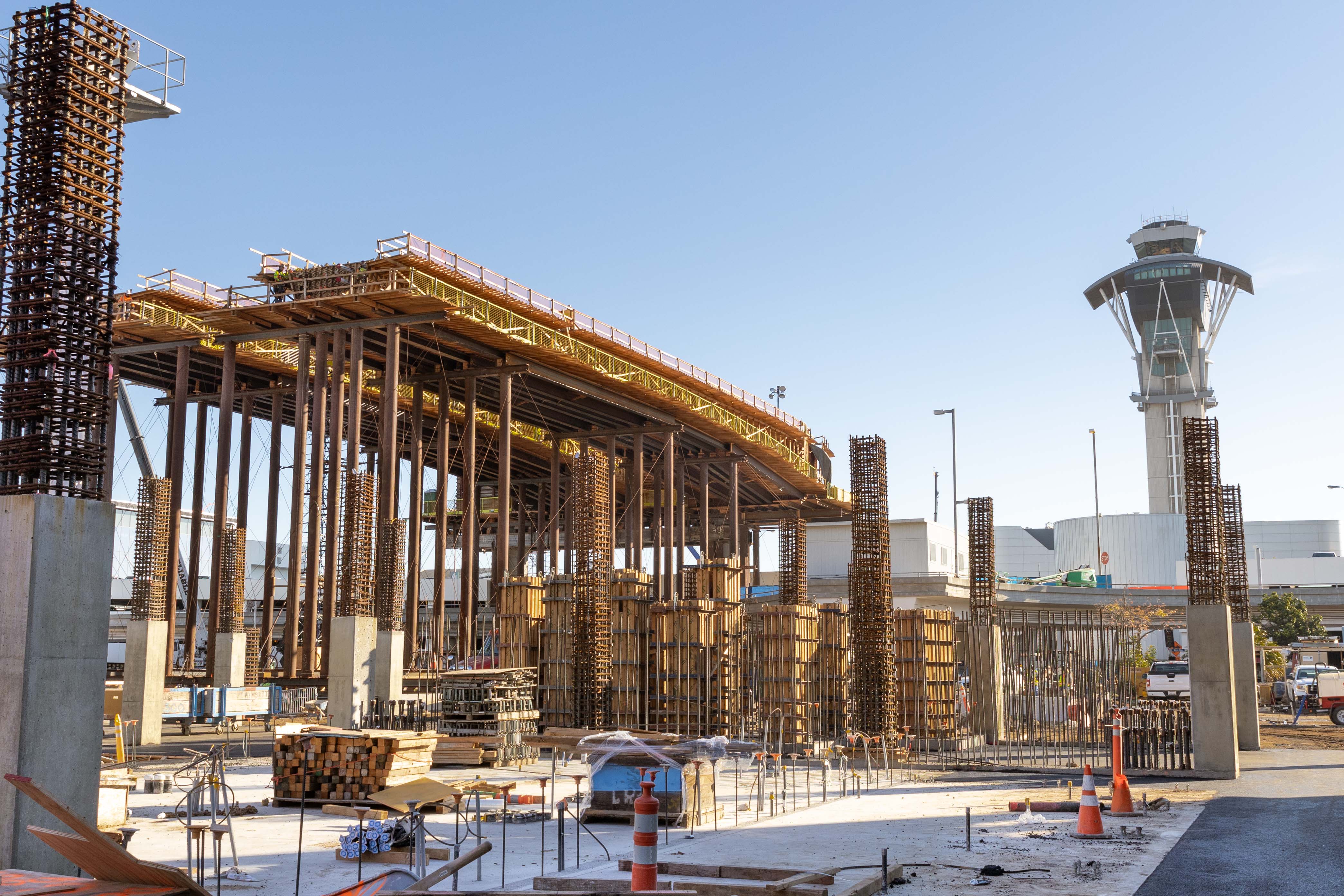 At the future West Central Terminal Area station, crews continue to advance guideway construction as support columns are constructed for a new parking structure.