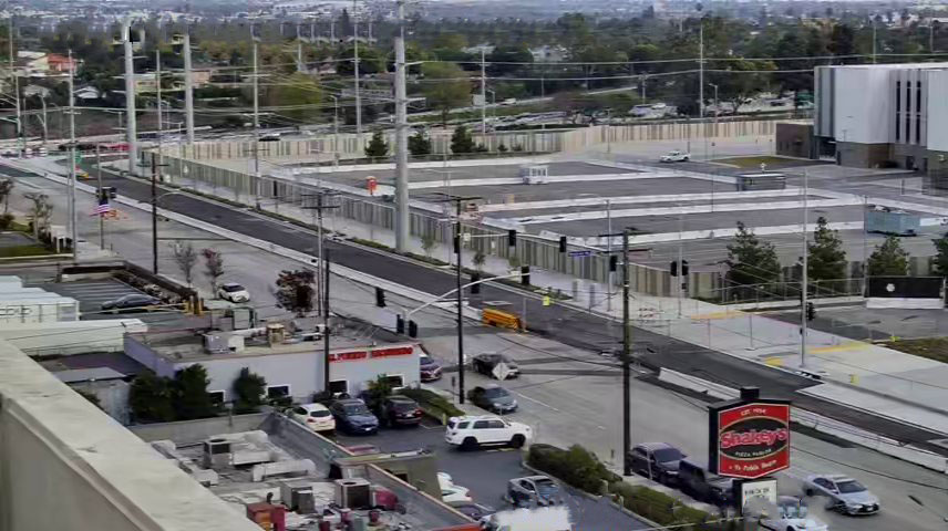 View looking east on Arbor Vitae Street showing street widening alongside the northern and eastern edges of Consolidated Rent-A-Car facility property.